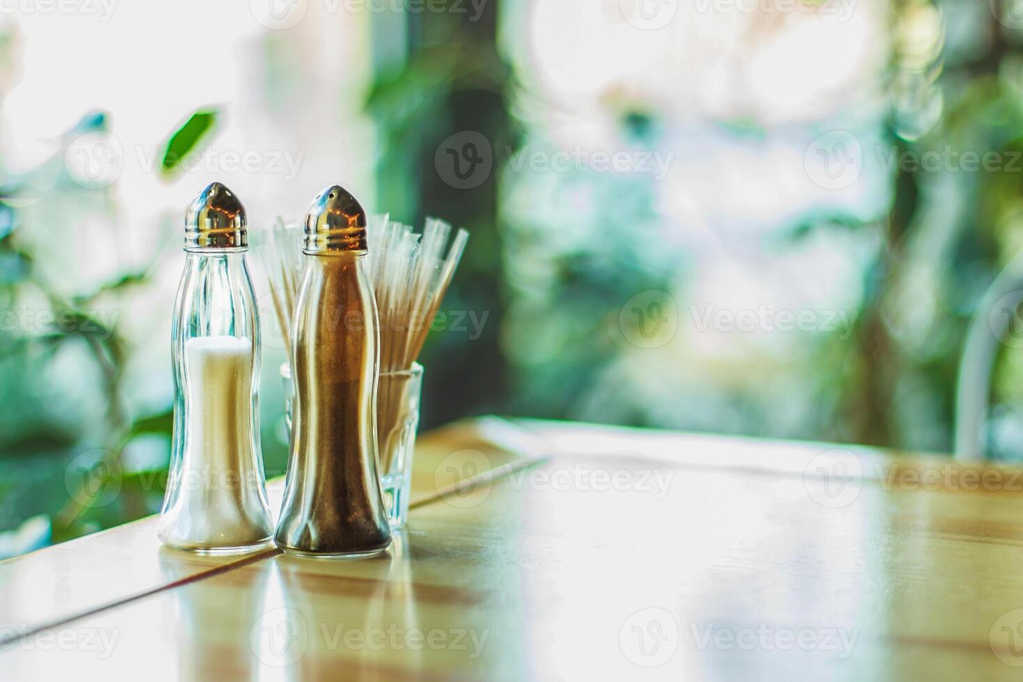 Salt shaker and pepper on the table photo