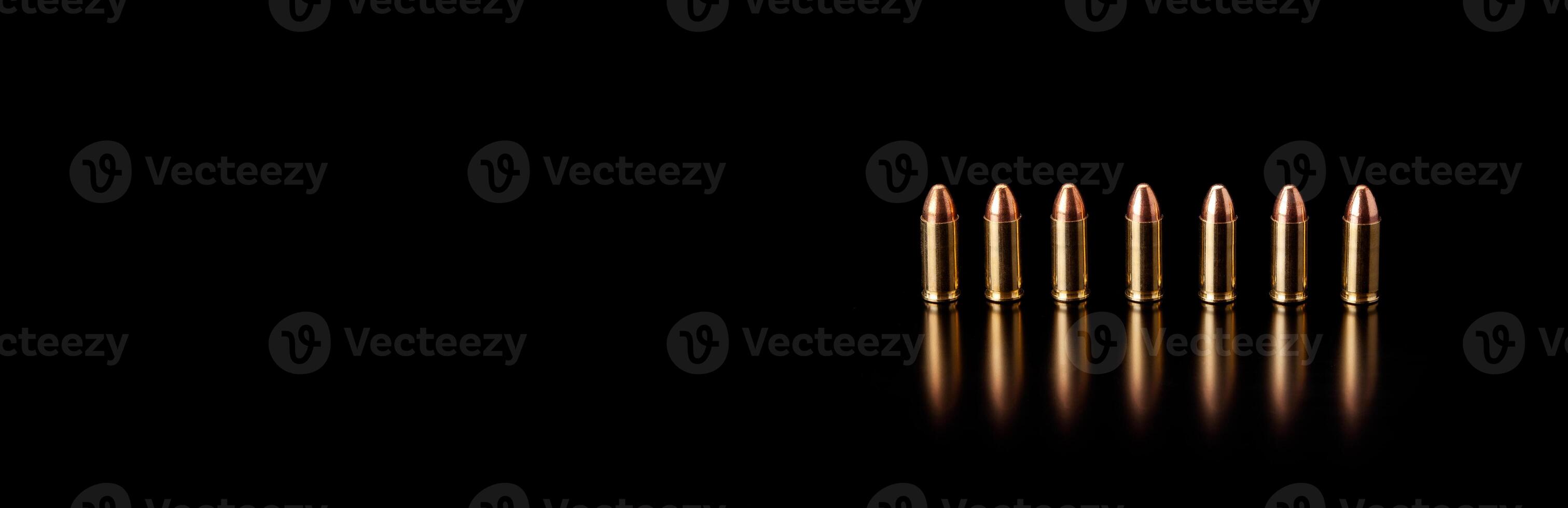 Bullet isolated on black background with reflexion. Rifle bullets close-up on black back. Cartridges for rifle and carbine on a black. photo