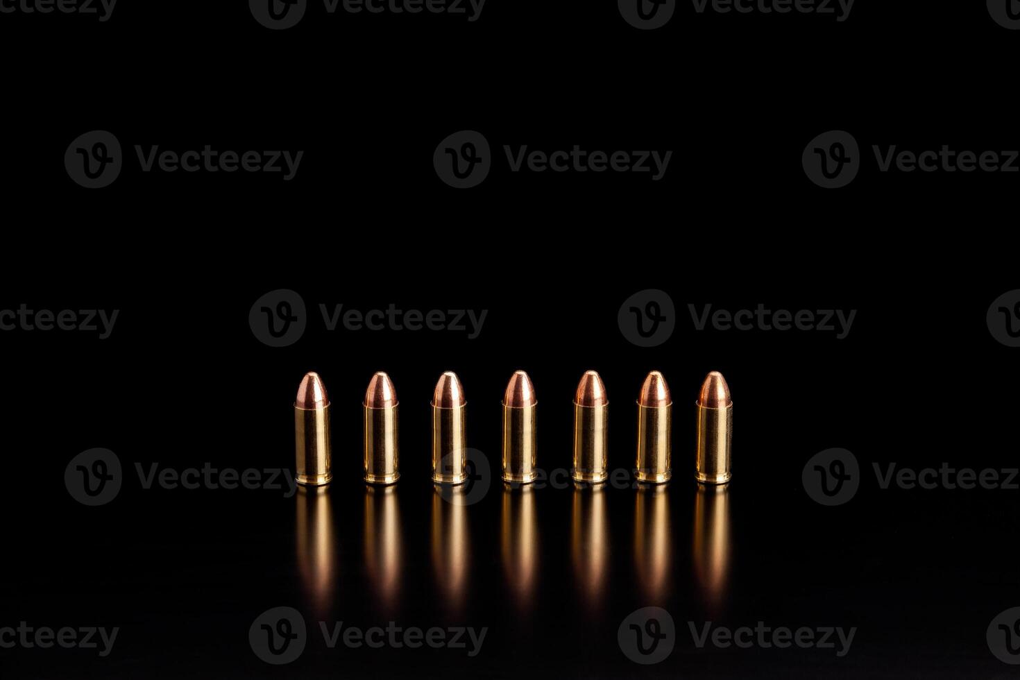 Bullet isolated on black background with reflexion. Rifle bullets close-up on black back. Cartridges for rifle and carbine on a black. photo