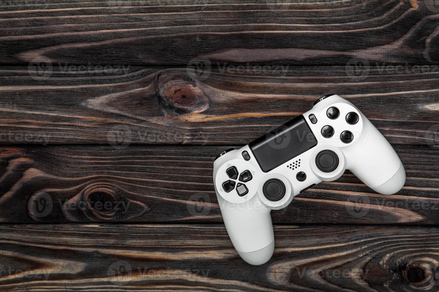 white gamepad on a dark wooden background photo
