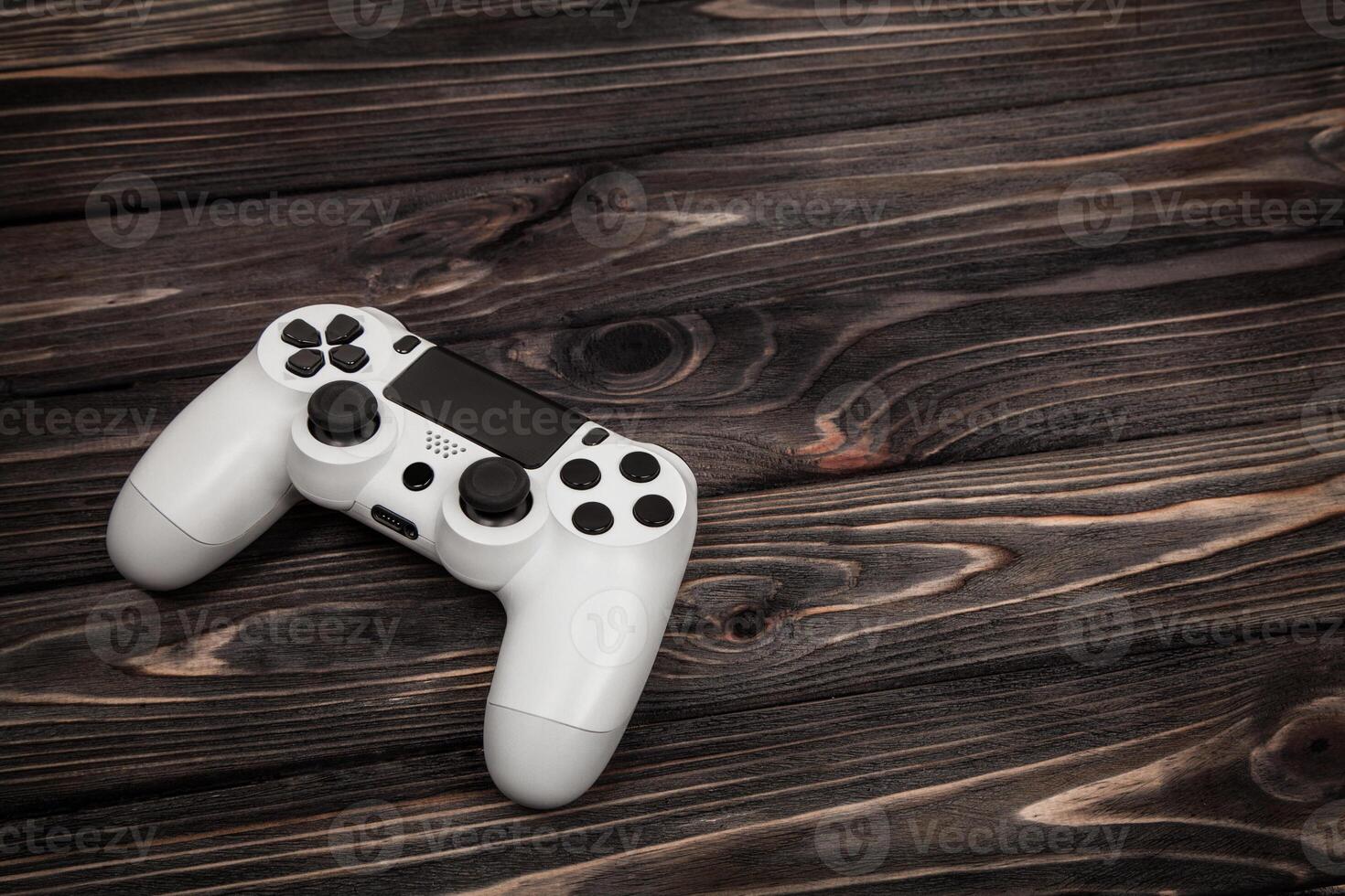 white gamepad on a dark wooden background photo