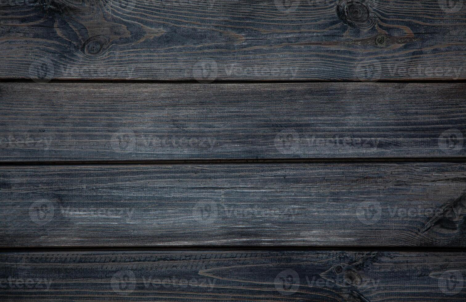 Medium brown wood texture backviewed from above. The wooden planks are stacked horizontally and have a worn look. photo