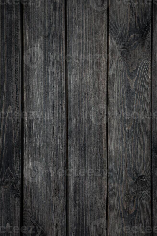 Medium brown wood texture backviewed from above. The wooden planks are stacked horizontally and have a worn look. photo