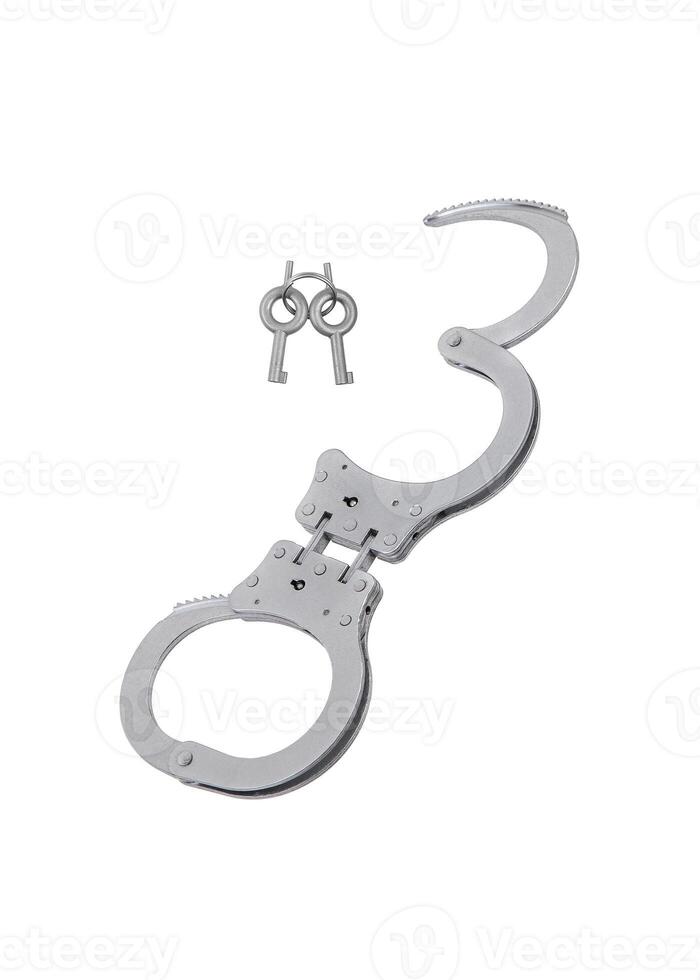 Metal handcuffs with keys for them. Bracelets for shackling detained criminals. Isolate on a white back. photo
