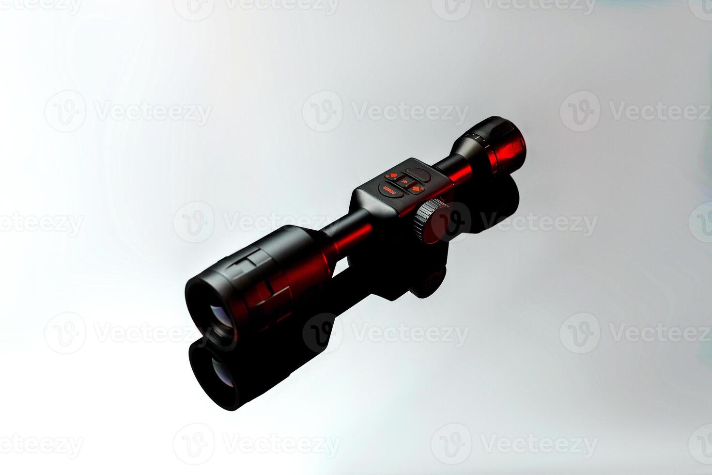 Modern telescopic sight on a smooth mirrored surface. The sight is highlighted in red. A device for shooting at long distances. photo