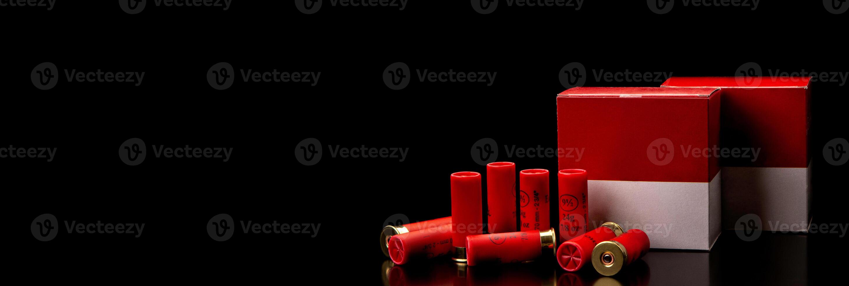 Shotgun cartridges. Ammunition for smooth-bore weapons. Boxes of cartridges on a black back. photo