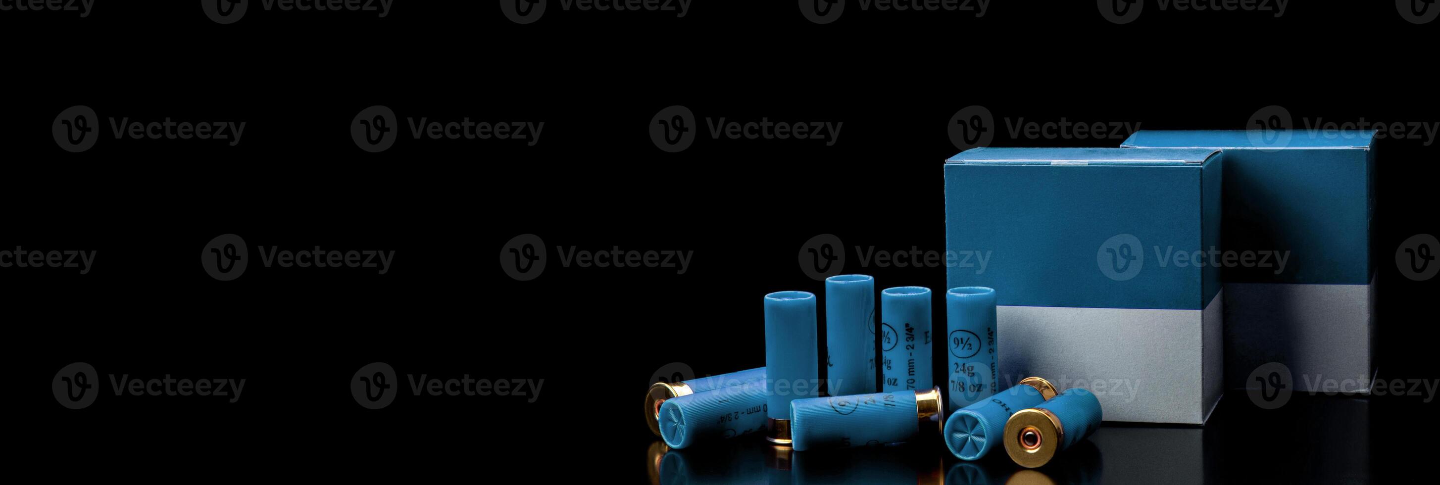 Shotgun cartridges. Ammunition for smooth-bore weapons. Boxes of cartridges on a black back. photo