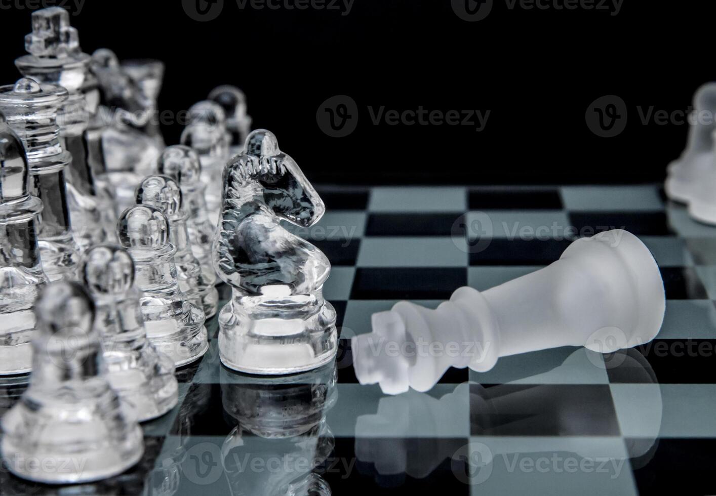glass chess. defeated king on a chessboard. photo