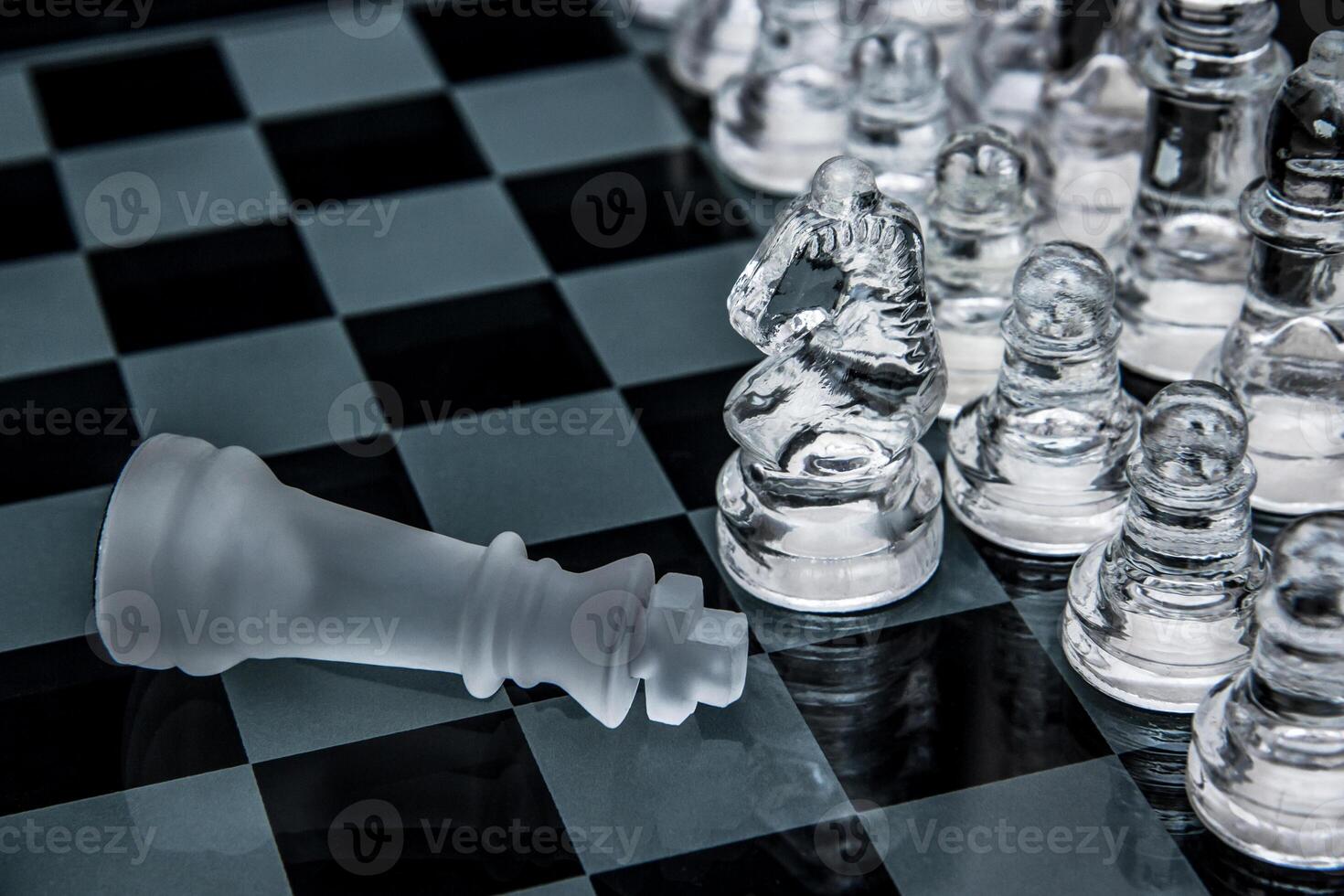glass chess. defeated king on a chessboard. photo