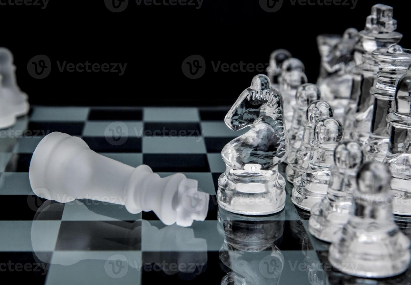 glass chess. defeated king on a chessboard. photo