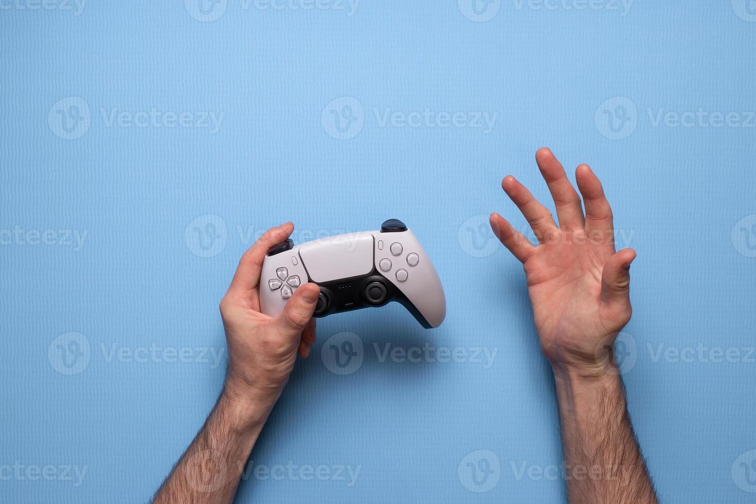 Hand hold new joystick. Gamer play game with gamepad controller. Gaming man holding simulator joypad. Person with keypad joystic in arms. Not understanding the situation. Gaming concept. photo