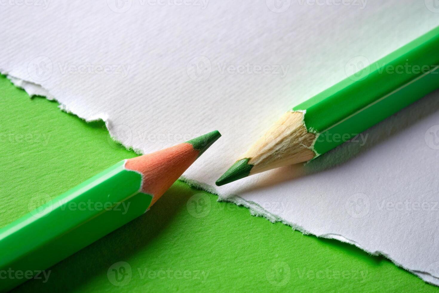 White paper torn ripped with pencil on green background for your presentation background photo