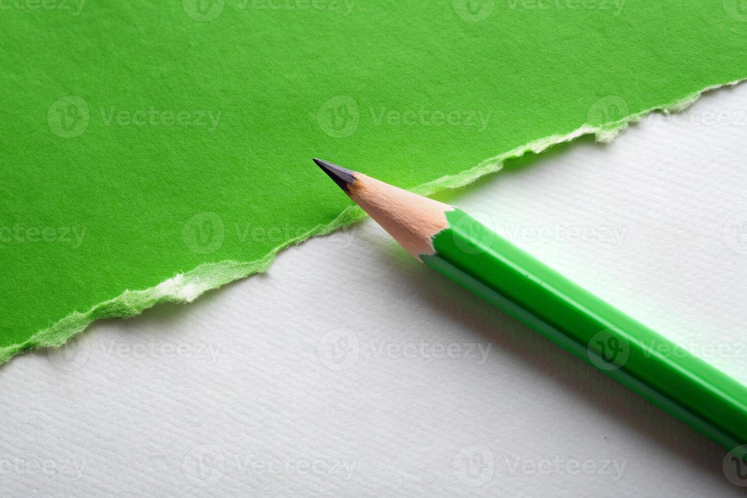 White paper torn ripped with pencil on green background for your presentation background photo