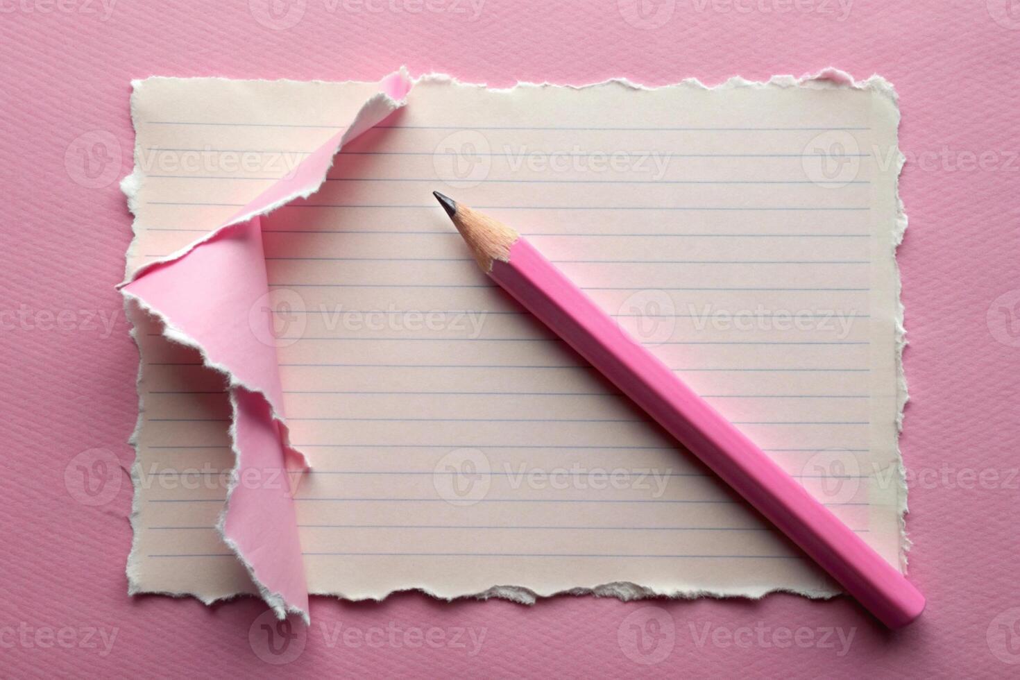 White paper torn ripped with pencil on pink background for your presentation background photo
