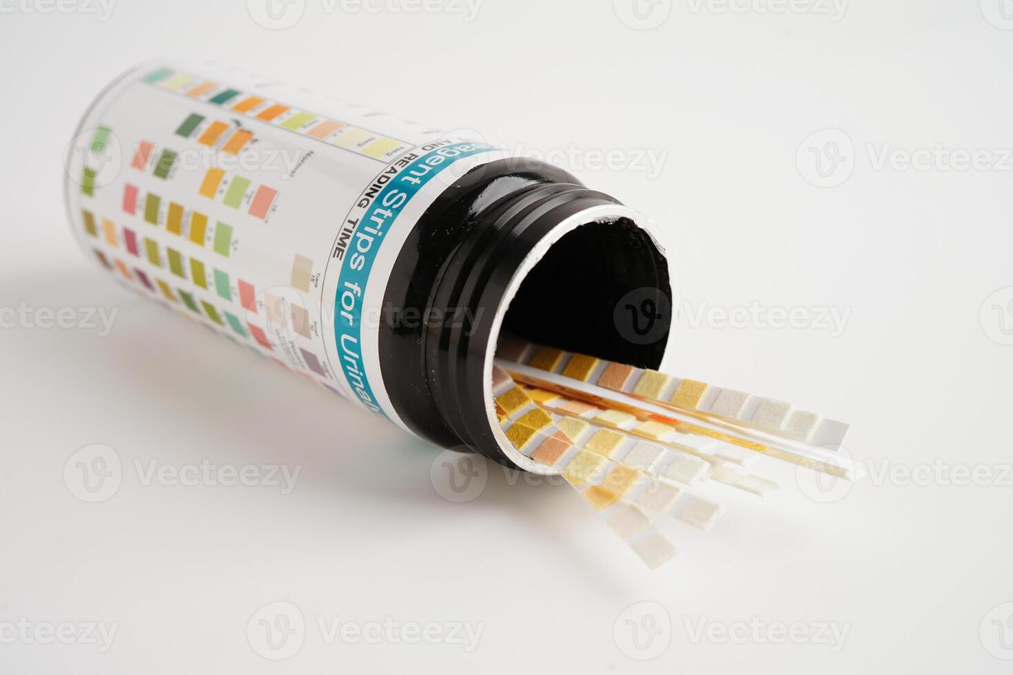 Urinalysis, urine cup with reagent strip pH paper test and comparison chart in laboratory. photo