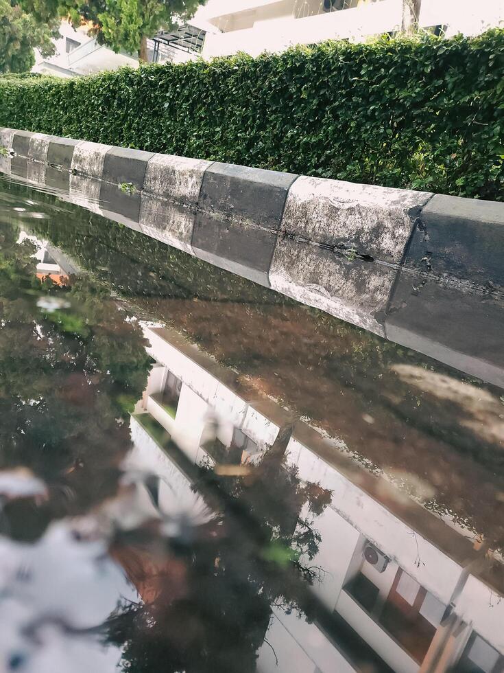 Reflection of a puddle after rain in front of a university building photo