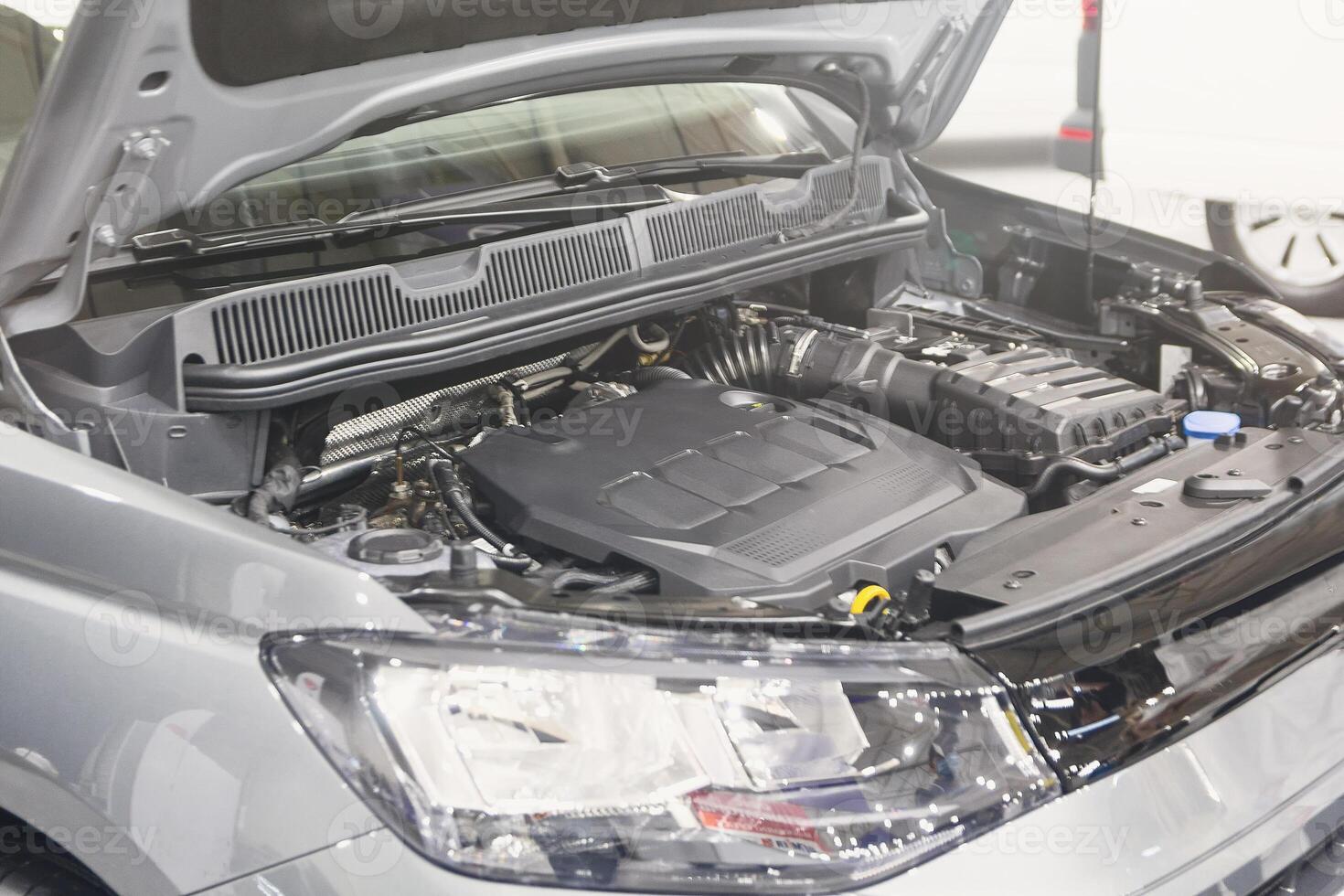 Car with open hood at a service station photo