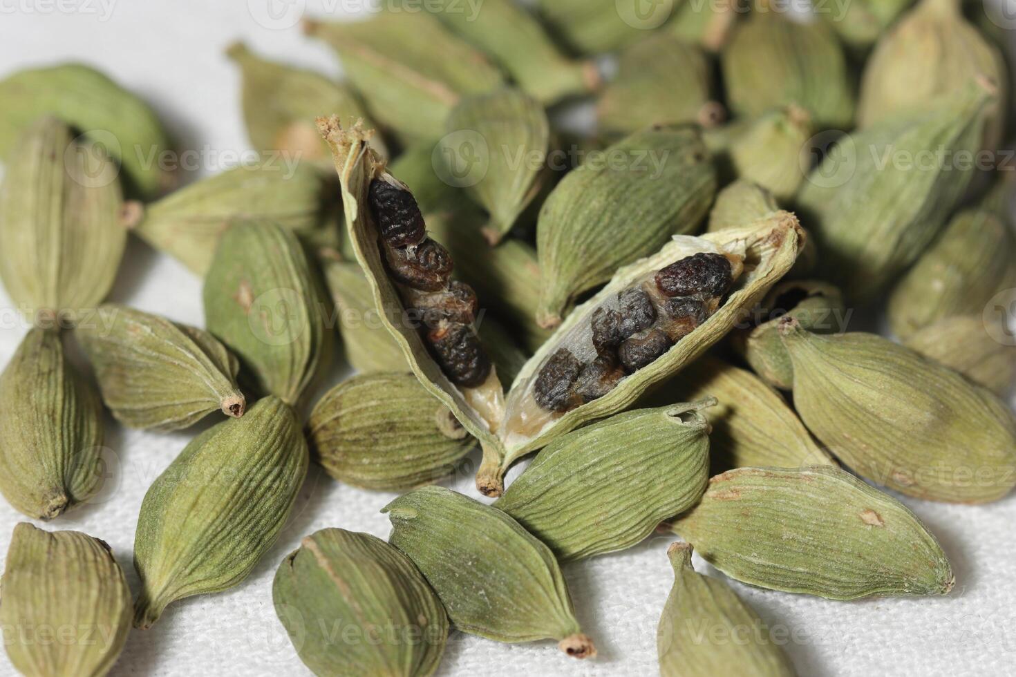 Cardamom pods with seeds isolated on white background with clipping path. photo
