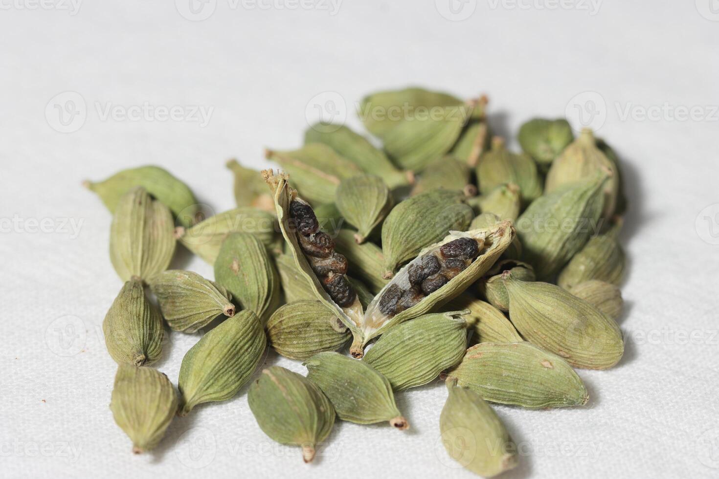 Cardamom pods with seeds isolated on white background with clipping path. photo