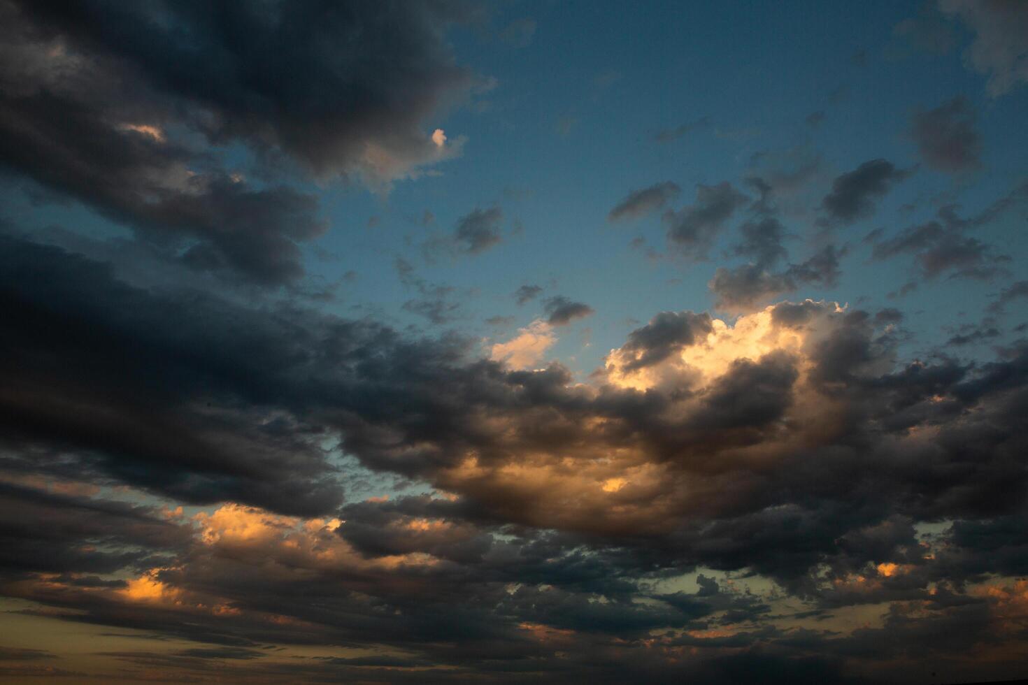 Cloudscape, Colored Clouds at Sunset near the Ocean in a Cloudy Day photo