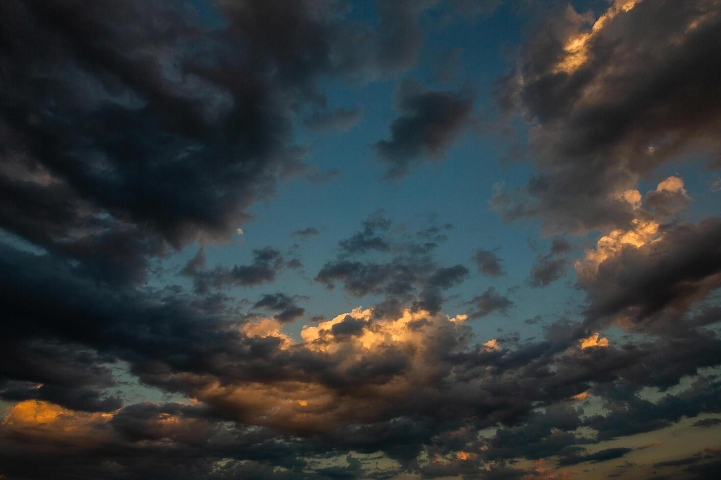 Cloudscape, Colored Clouds at Sunset near the Ocean in a Cloudy Day photo