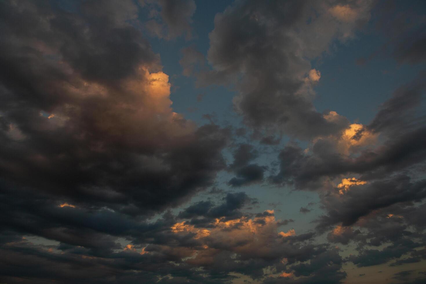 Cloudscape, Colored Clouds at Sunset near the Ocean in a Cloudy Day photo