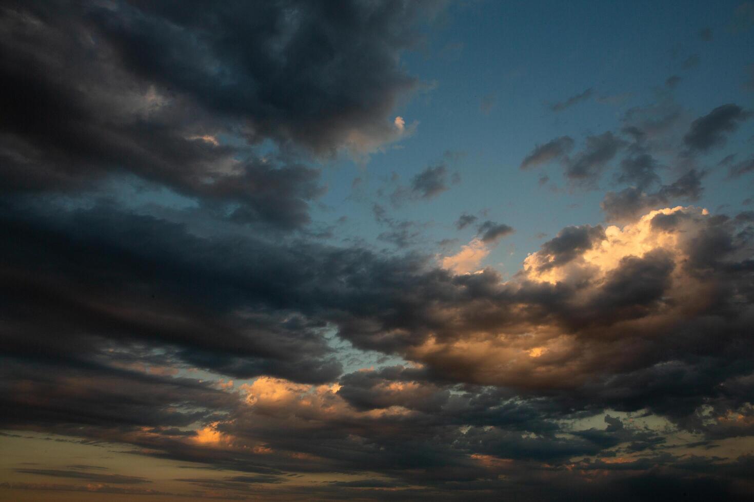 Cloudscape, Colored Clouds at Sunset near the Ocean in a Cloudy Day photo
