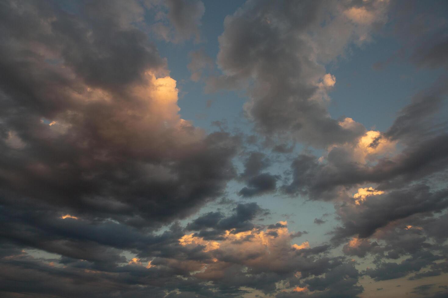 Cloudscape, Colored Clouds at Sunset near the Ocean in a Cloudy Day photo