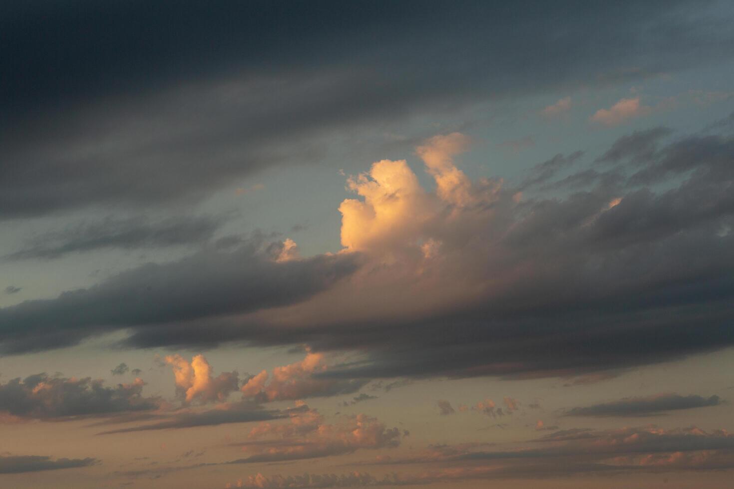 Cloudscape, Colored Clouds at Sunset near the Ocean in a Cloudy Day photo
