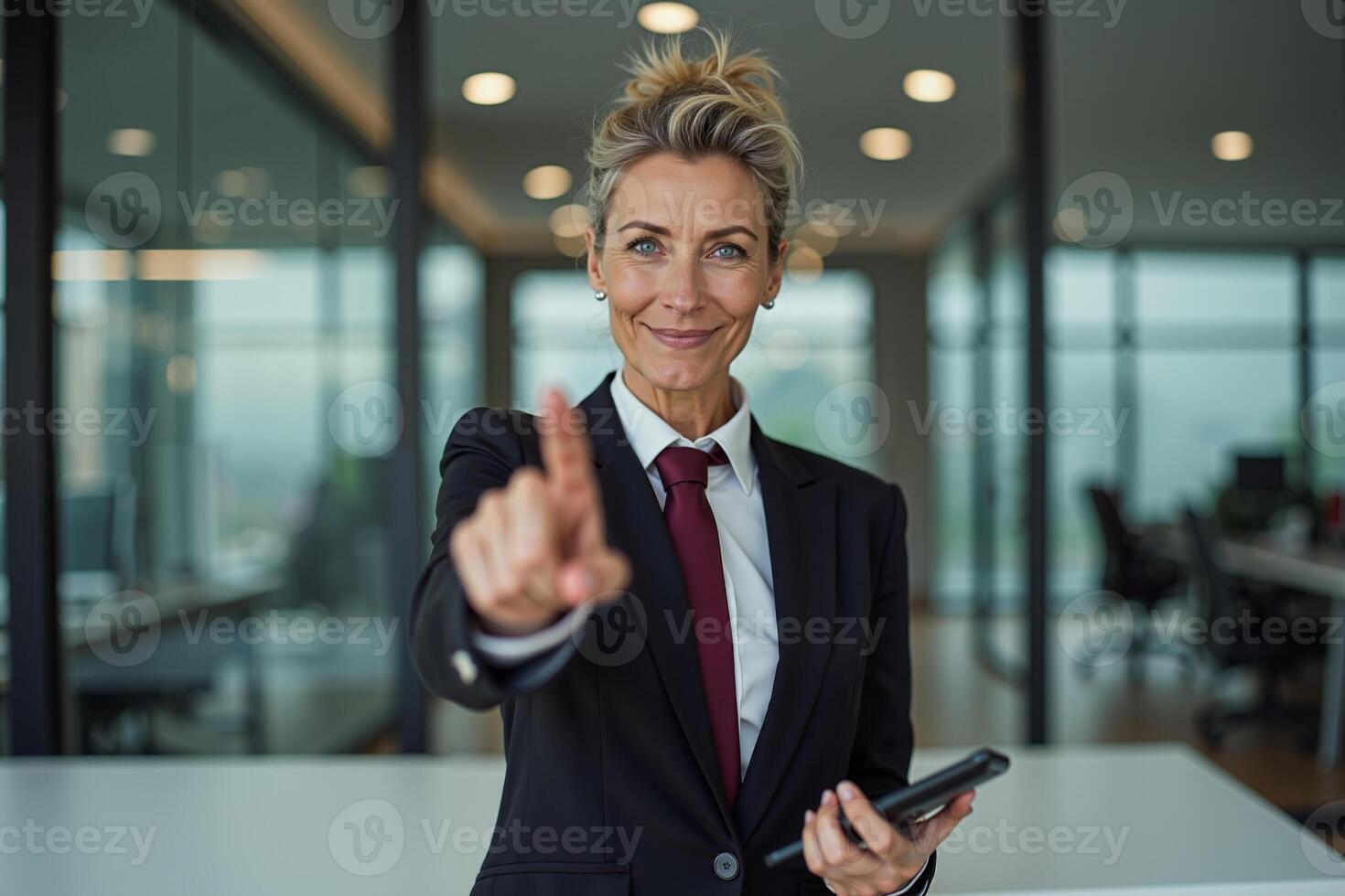 photo of woman in suit outfit pointing index finger in the office,