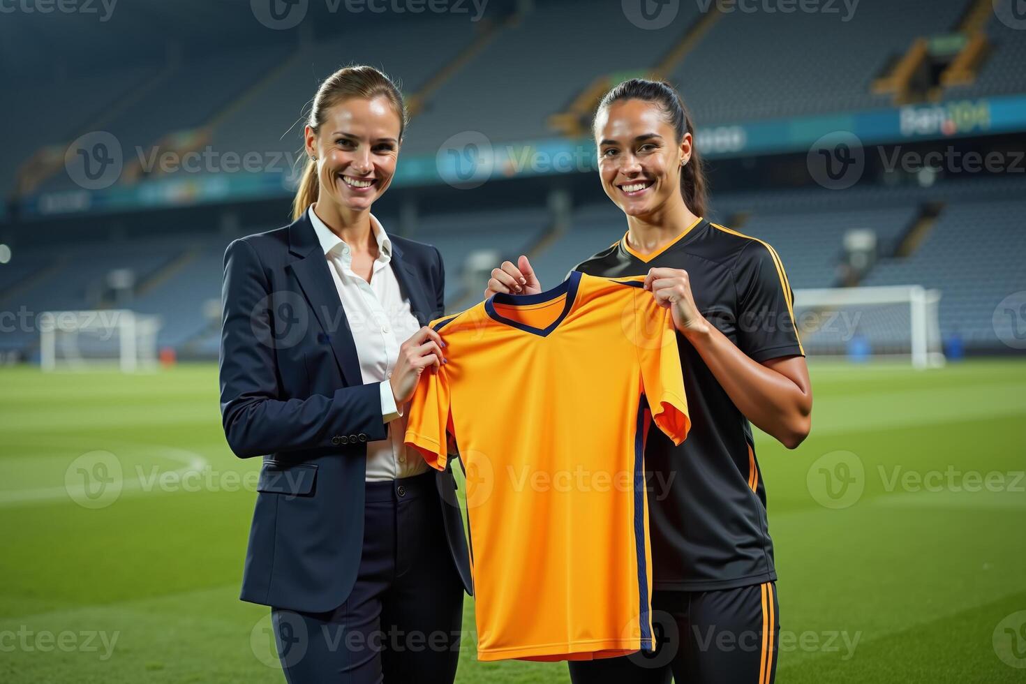 photo of coach and player holding shirt in the stadium field at signing contract event,