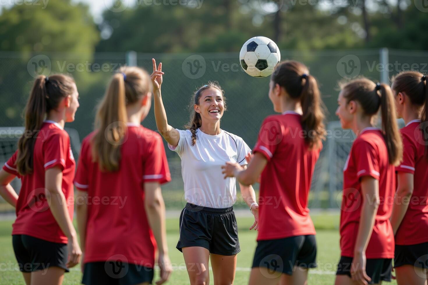 photo of coach instructor trainer teaching teenage player at soccer field,