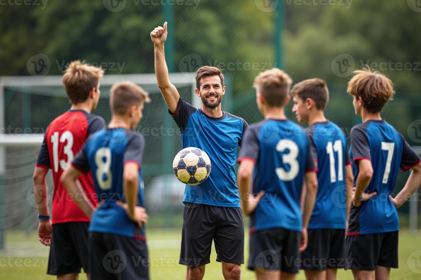 photo of coach instructor trainer teaching teenage player at soccer field,