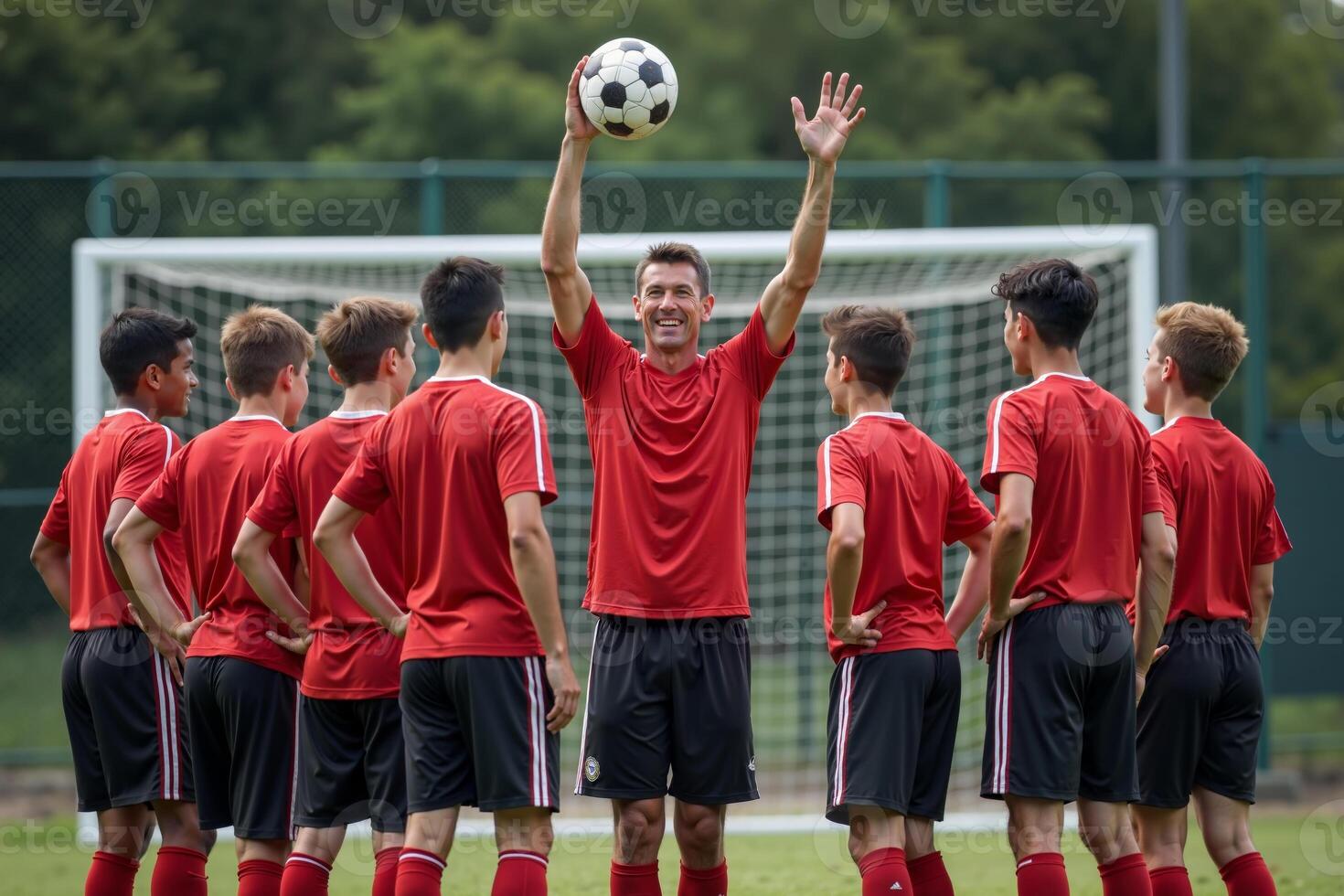 photo of coach instructor trainer teaching teenage player at soccer field,