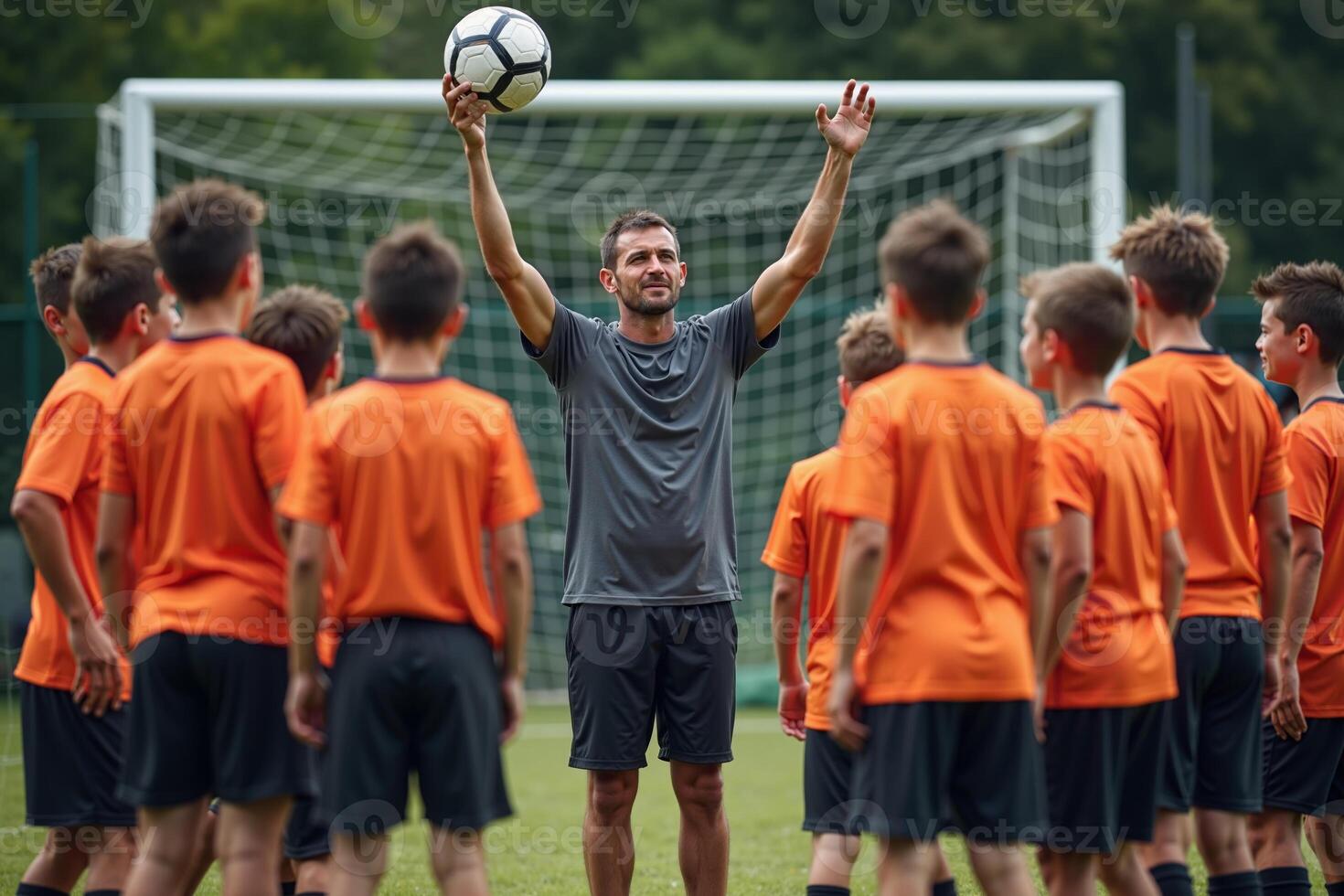 photo of coach instructor trainer teaching teenage player at soccer field,