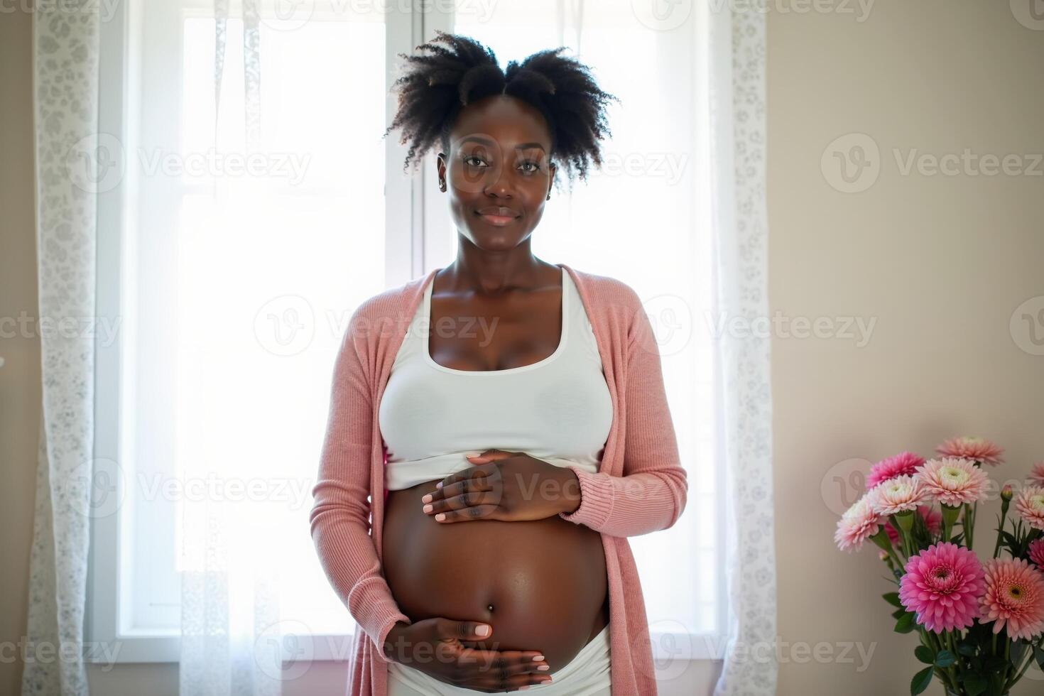 photo of pregnant woman relaxing standing both hands touching her belly at her house,