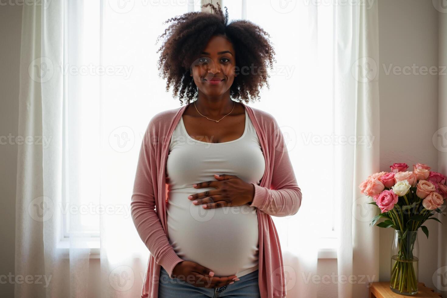 photo of pregnant woman relaxing standing both hands touching her belly at her house,