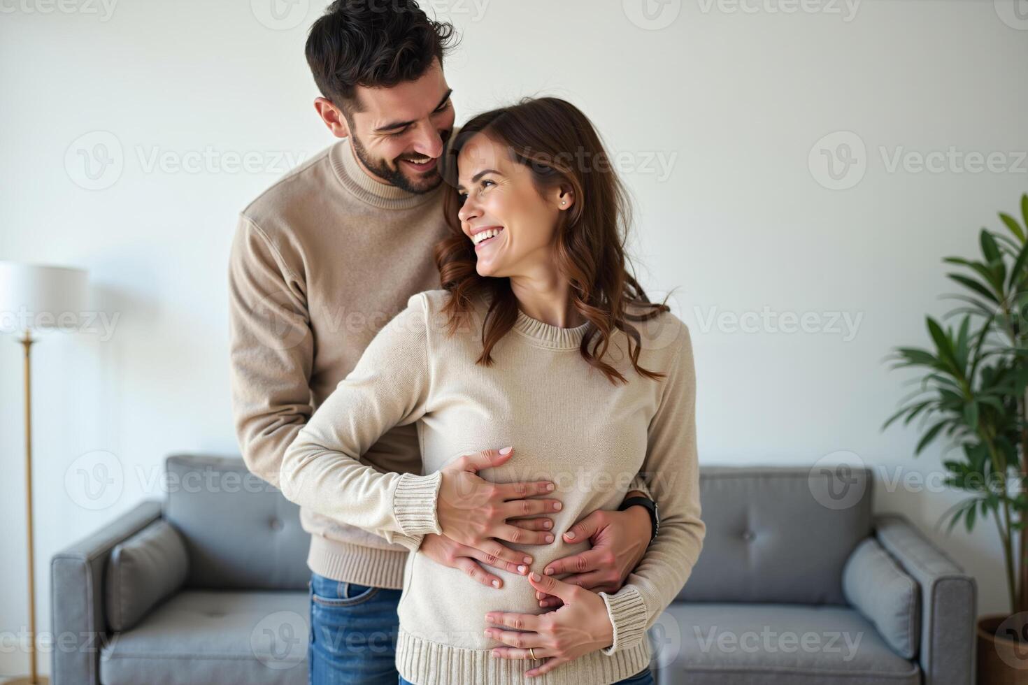 photo of couple man and pregnant woman relaxing standing both hands touching her belly at house,
