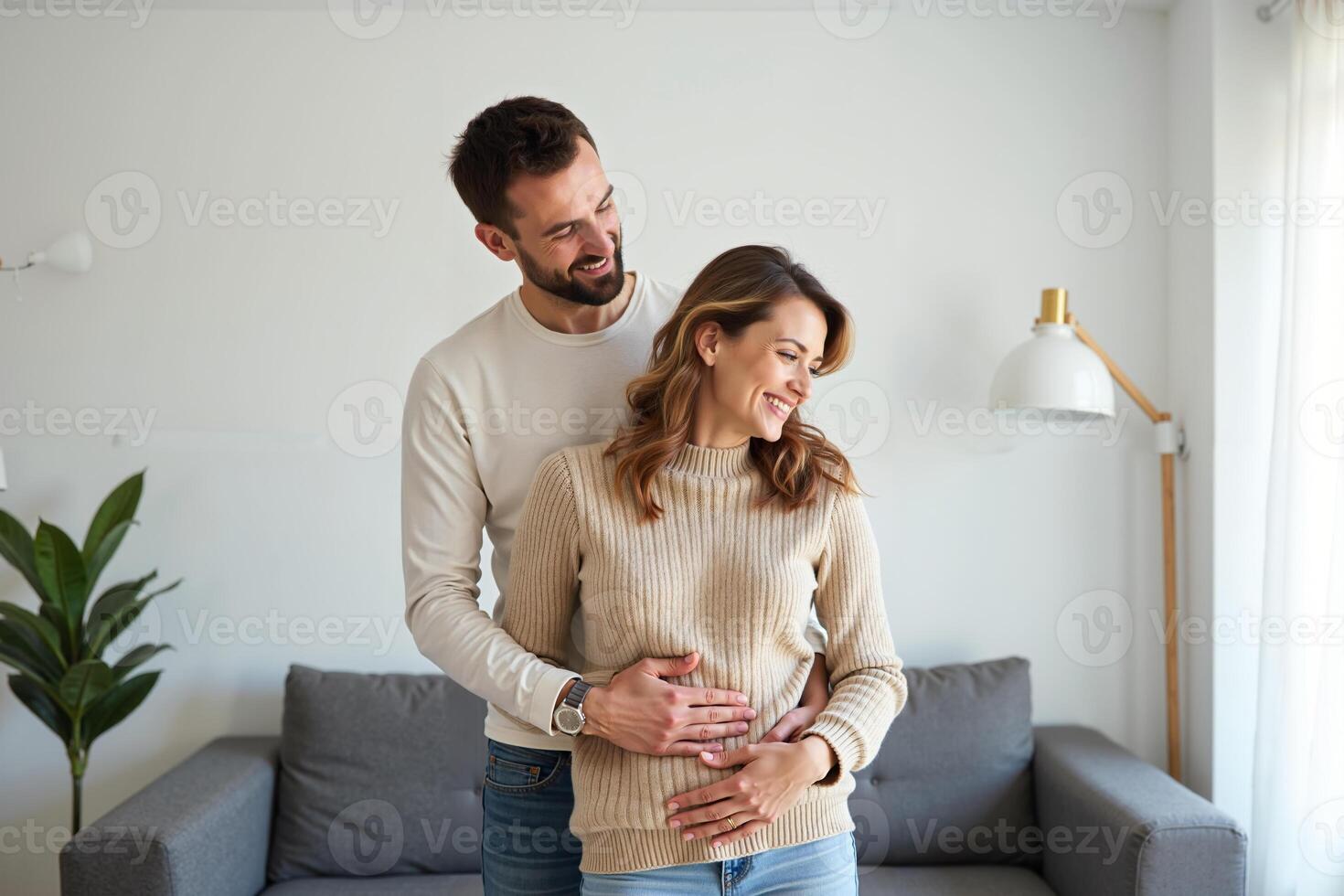 photo of couple man and pregnant woman relaxing standing both hands touching her belly at house,