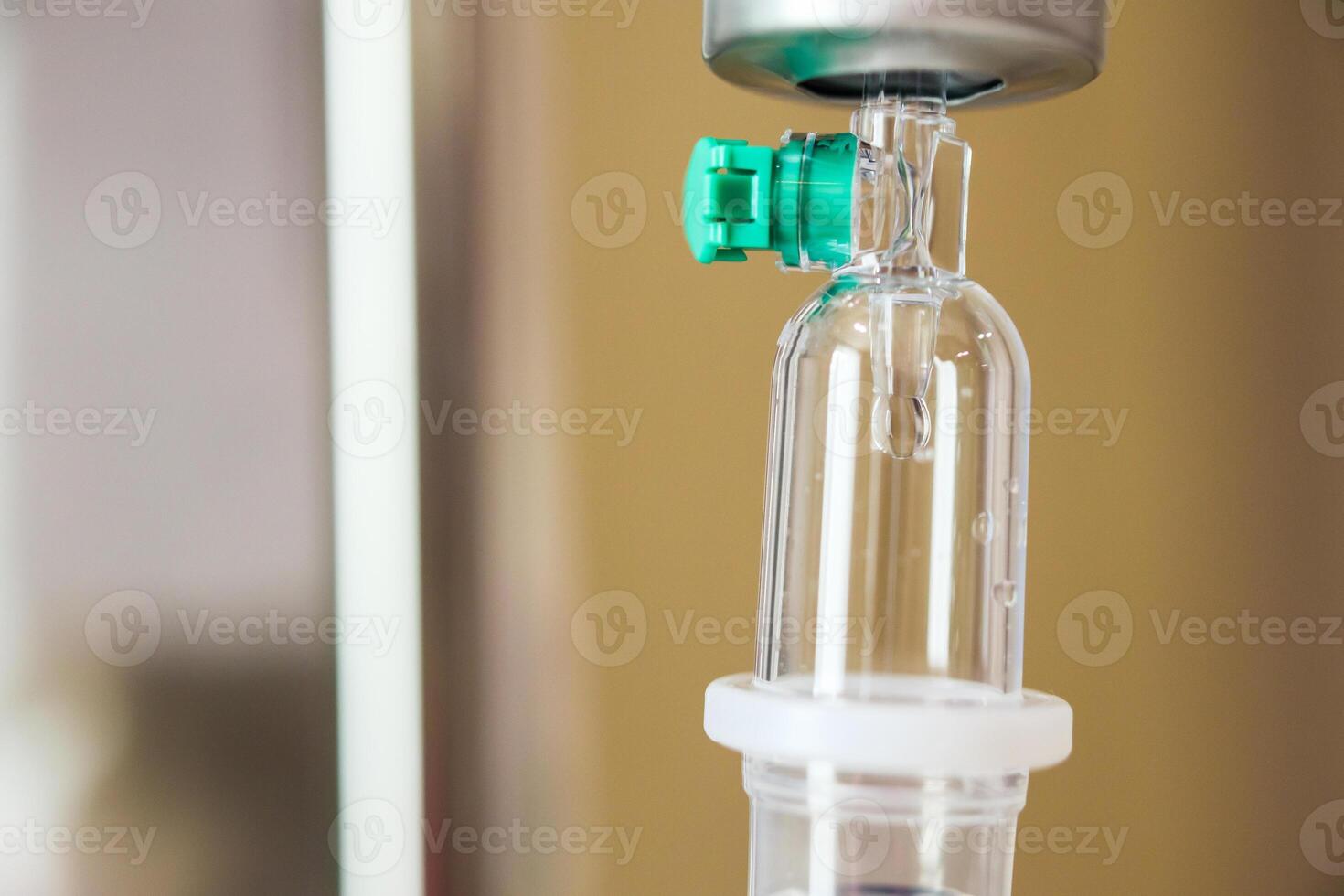 Close up medical intravenous IV drip in hospital background photo