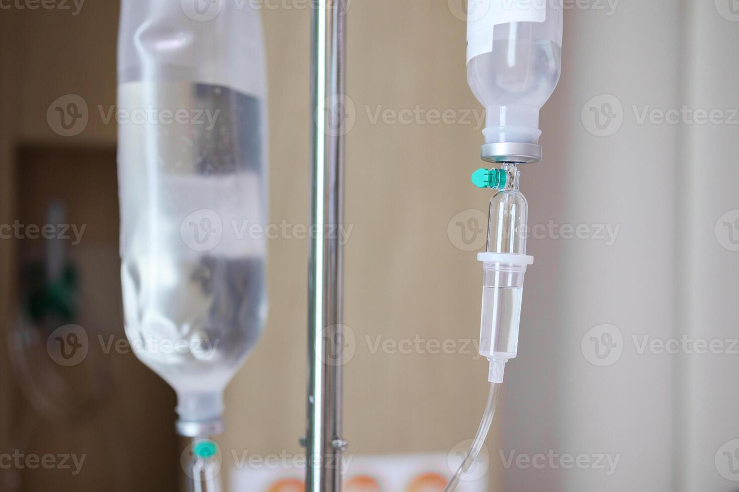 Close up medical intravenous IV drip in hospital background photo