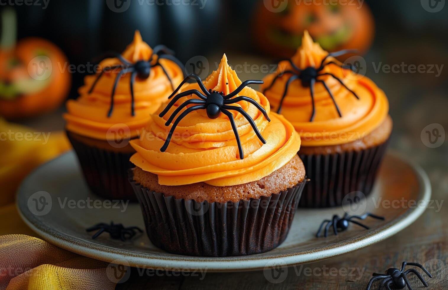 Halloween themed cupcakes with spider decorations are creatively arranged on a festive plate for display photo