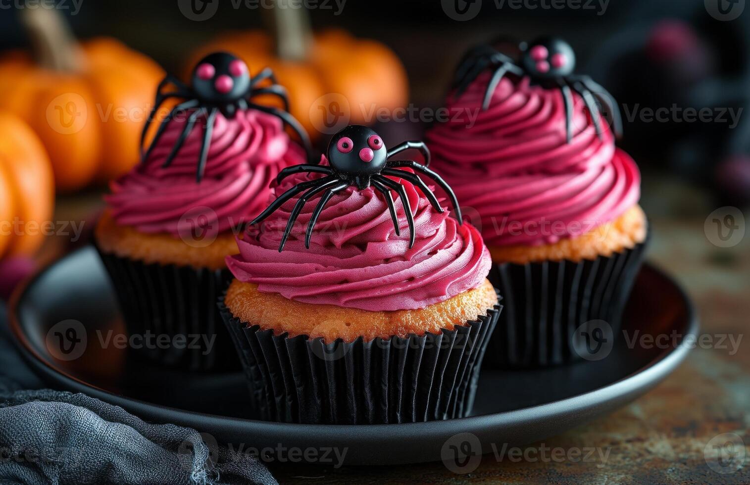 Halloween themed cupcakes with spider decorations are creatively arranged on a festive plate for display photo