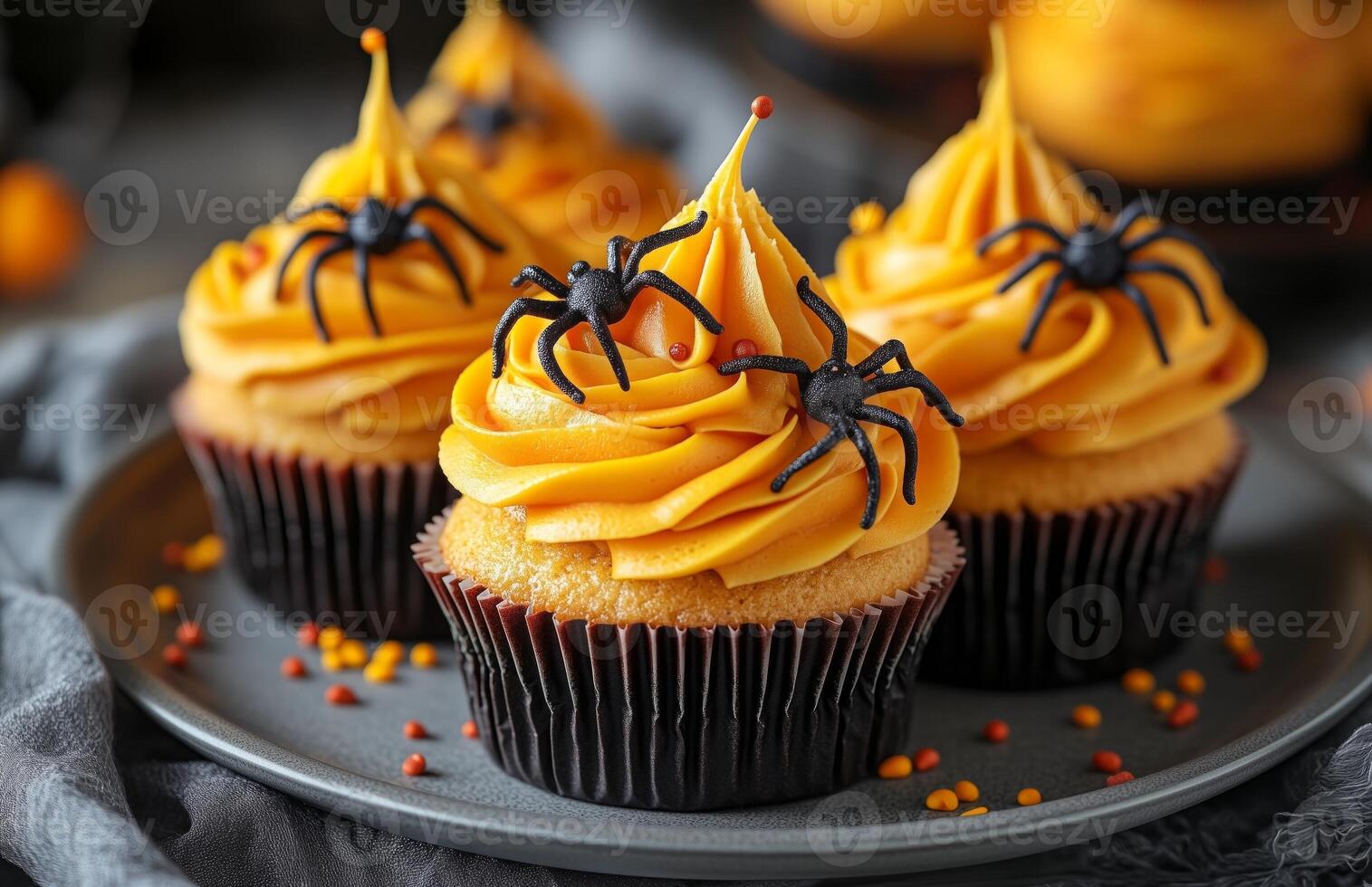Halloween themed cupcakes with spider decorations are creatively arranged on a festive plate for display photo