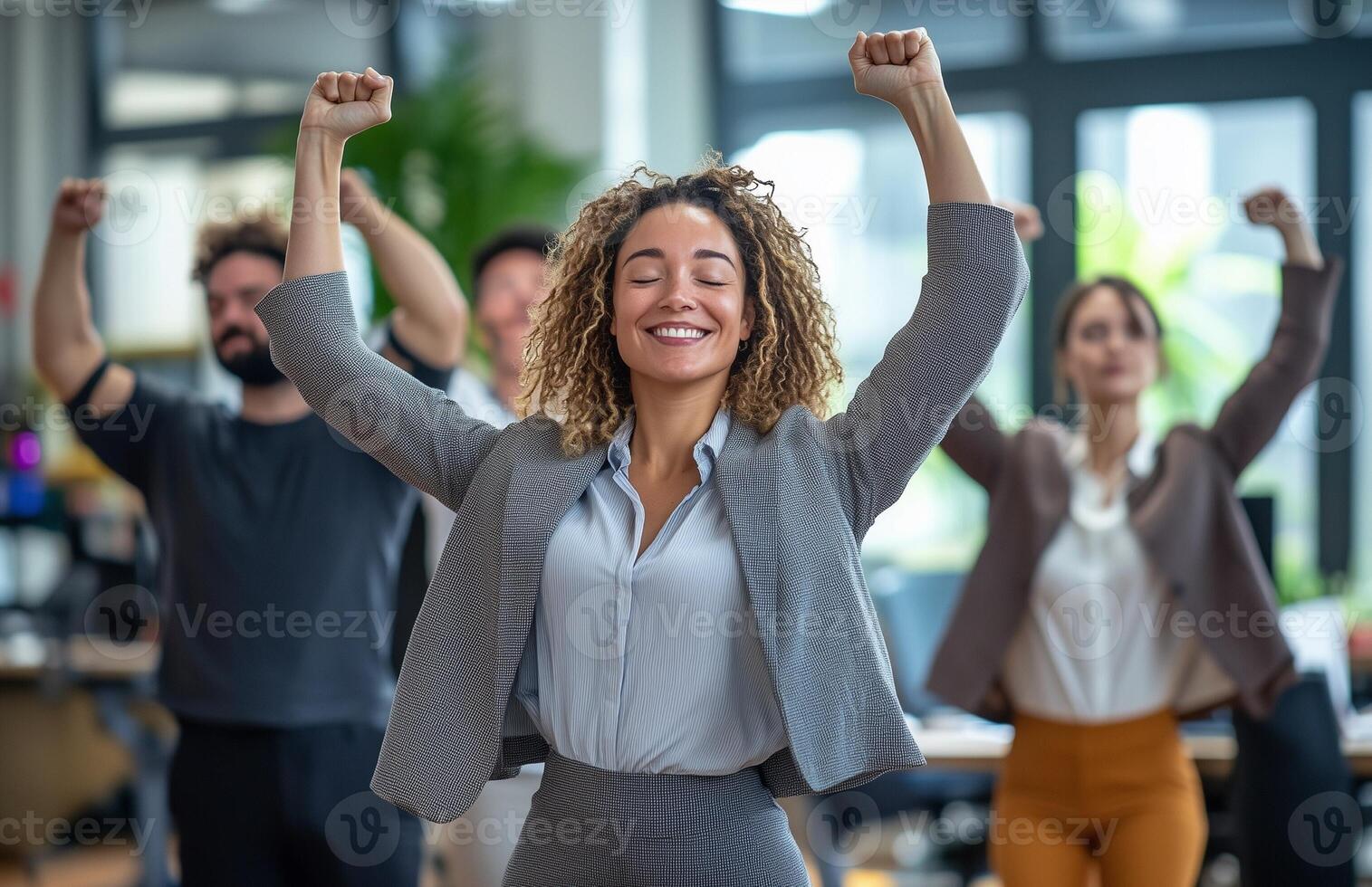 Office workers from different backgrounds engaged in group stretching exercises during a break photo