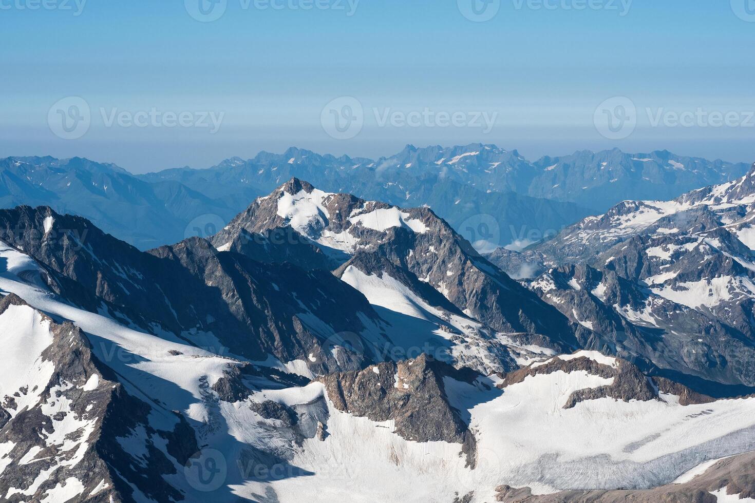 highlands landscape, mountain ranges with glaciers in atmospheric haze photo