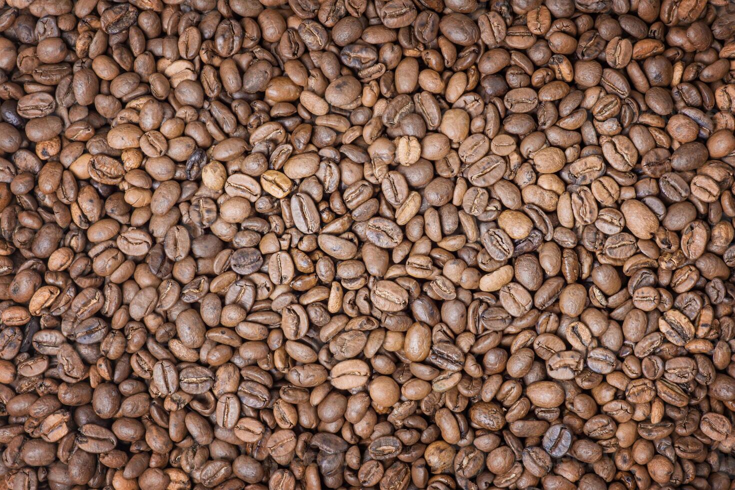 Roasted coffee beans as a background. Coffee, cheerfulness photo