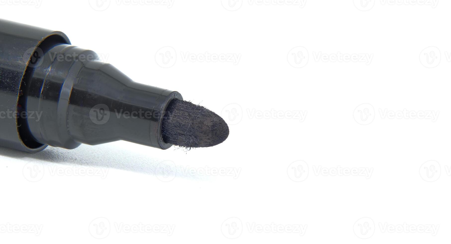 Close-up of black permanent marker with white background for office and art use photo