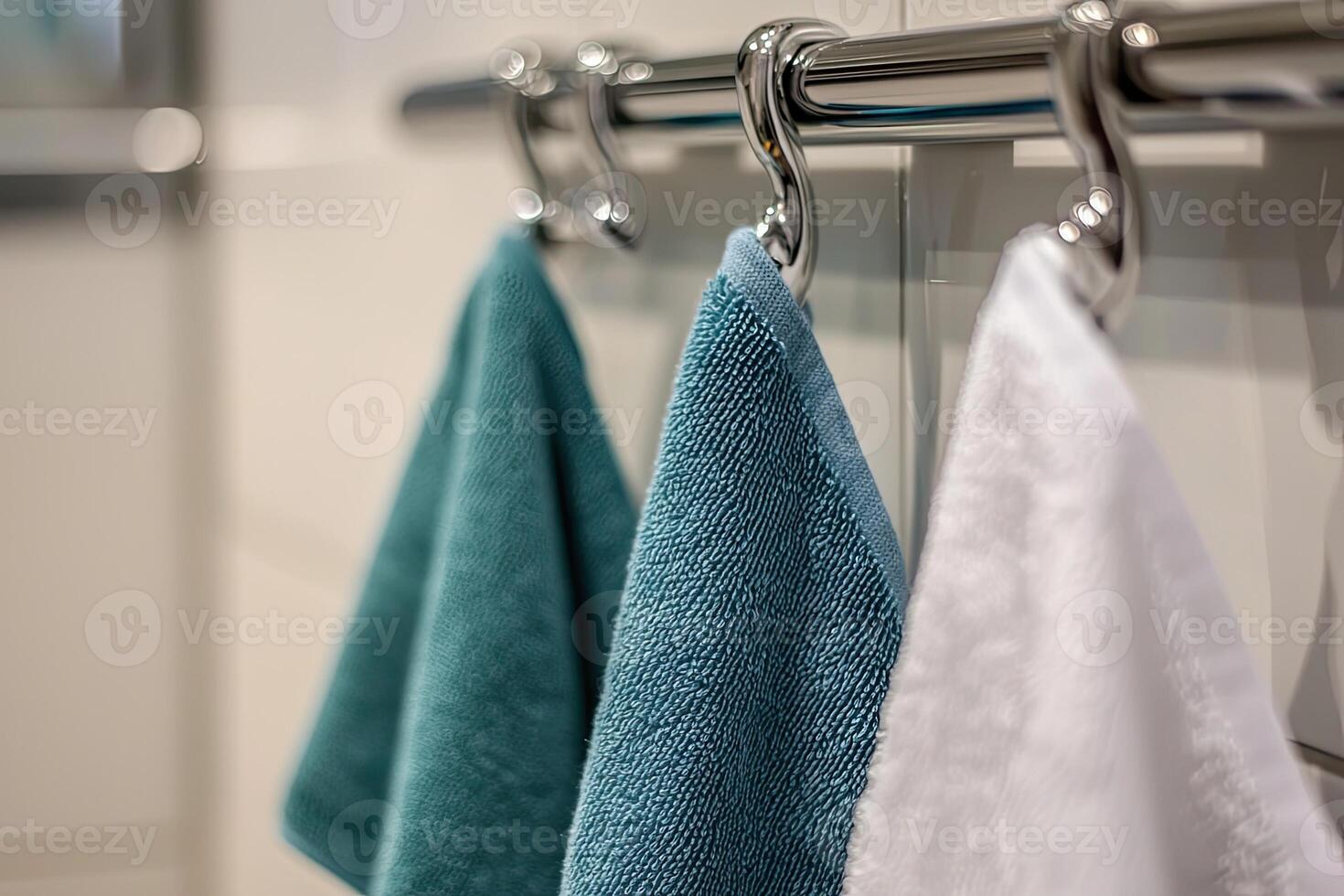 Kitchen towels hanging on a rack on a white brick wall photo