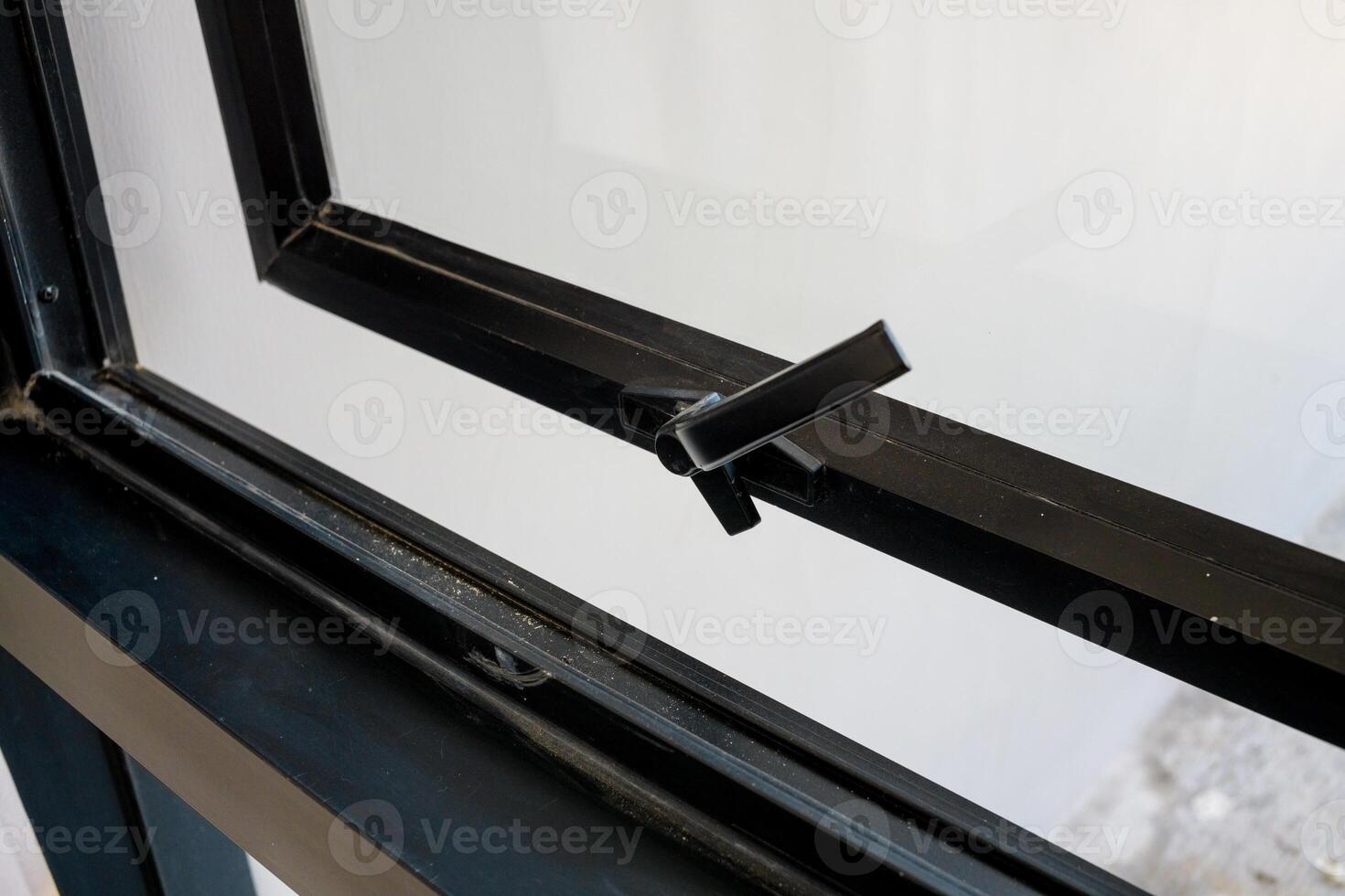 The handle of the new plastic door. black front door in a house under construction photo